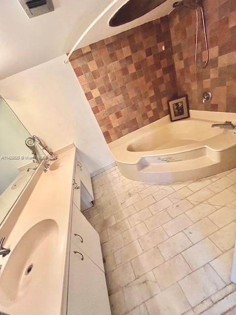 bathroom featuring shower / bath combination, tile patterned flooring, visible vents, and vanity