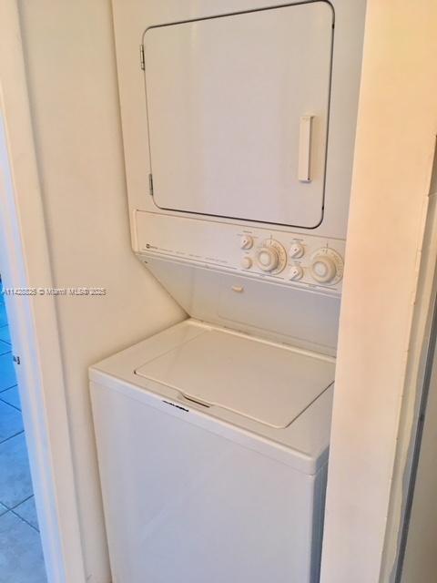 clothes washing area with laundry area and stacked washer / dryer