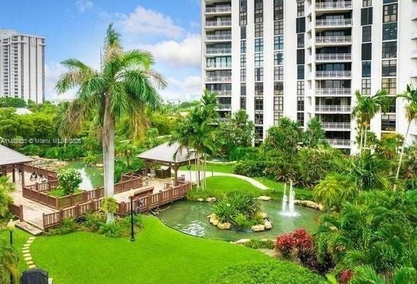 surrounding community featuring a water view and a yard