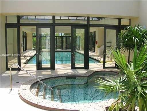 community pool featuring a community hot tub and a patio