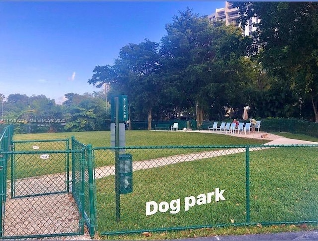 view of home's community featuring a yard and fence