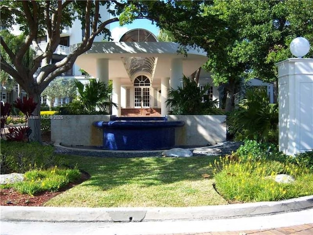 view of front of house featuring a front lawn and stucco siding