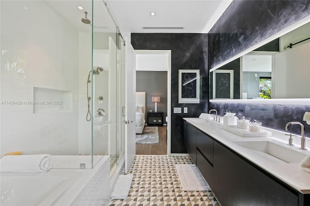 bathroom with vanity, an enclosed shower, and tile walls