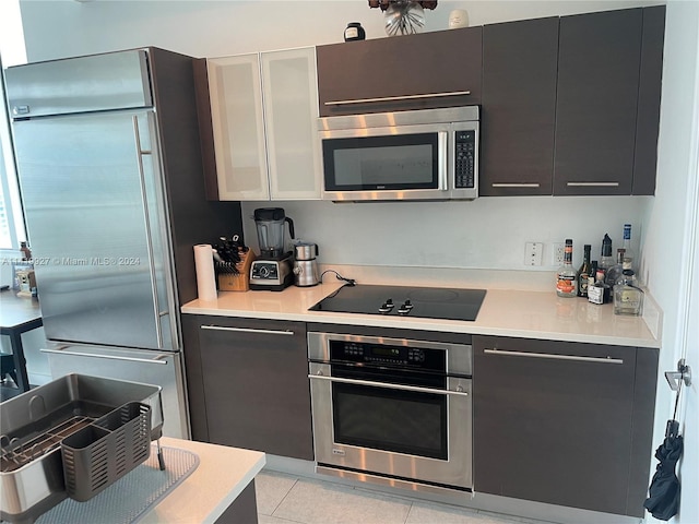 kitchen with stainless steel appliances and light tile patterned floors