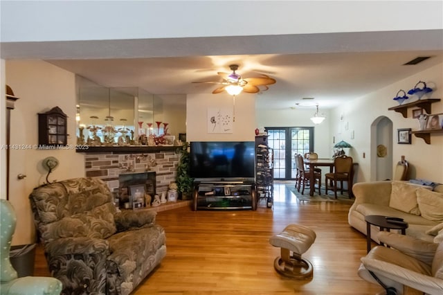 2533 Fillmore St, Hollywood, FL 33020 - living room featuring a fireplace, ceiling fan, and light wood-type flooring