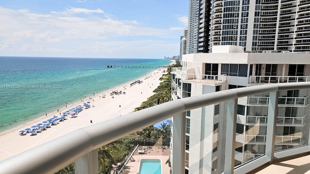 exterior space featuring a water view, a community pool, and a view of the beach