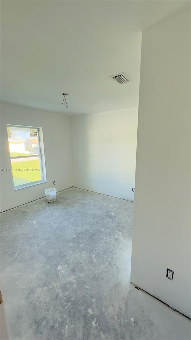 unfurnished room with visible vents