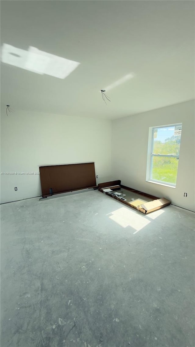 additional living space featuring concrete flooring