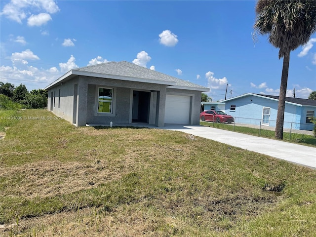 single story home with a front lawn, fence, stucco siding, a garage, and driveway