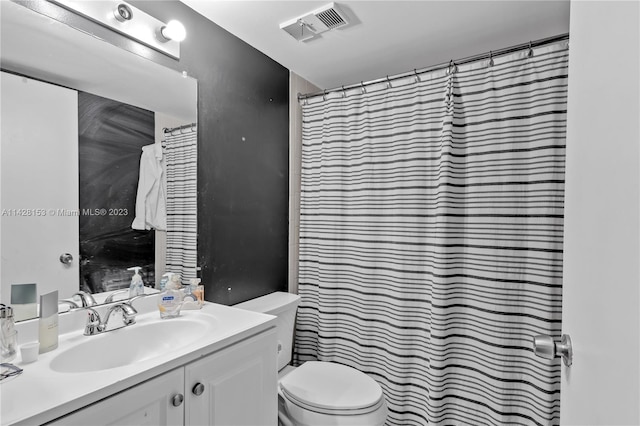 bathroom featuring toilet and large vanity