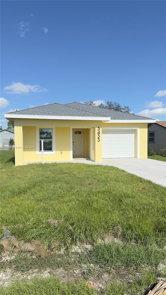 view of front facade with a front lawn and a garage