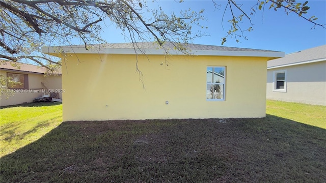 rear view of property featuring a yard