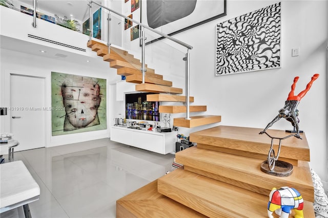 tiled living room featuring a towering ceiling