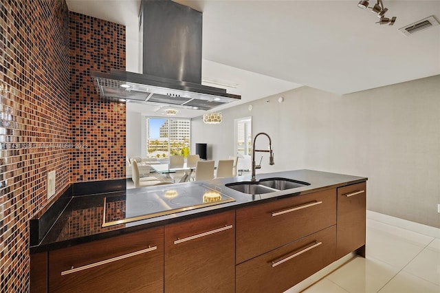 kitchen featuring sink, extractor fan, light tile floors, and black electric cooktop