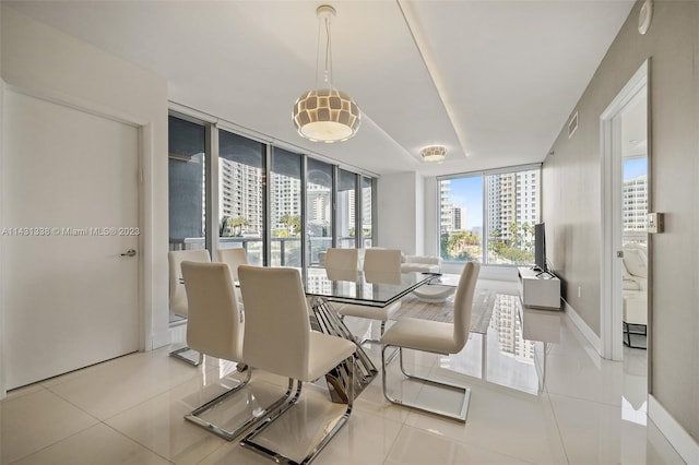 dining room featuring light tile floors and a wall of windows