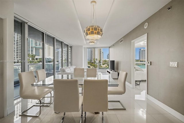 tiled dining space with french doors, a healthy amount of sunlight, and expansive windows