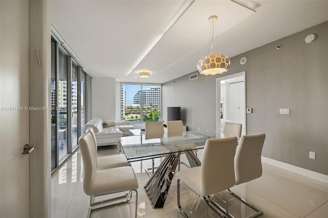 tiled dining space featuring expansive windows