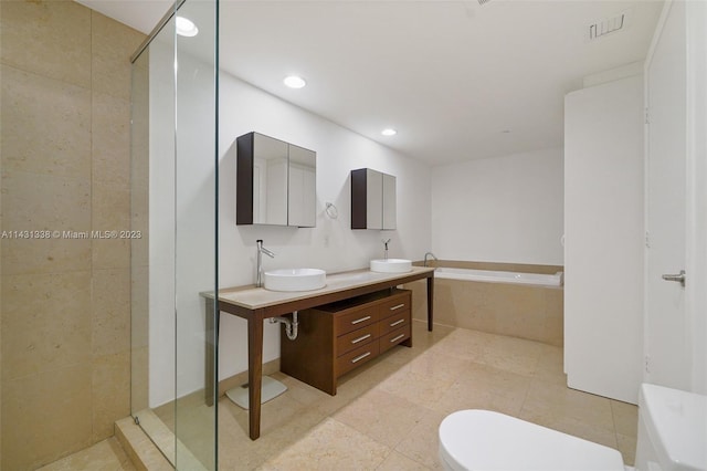 full bathroom featuring double sink vanity, tile floors, plus walk in shower, and toilet