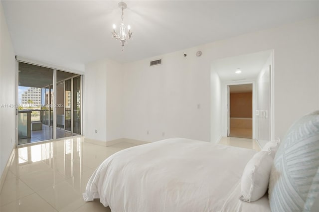 tiled bedroom featuring a notable chandelier, floor to ceiling windows, and access to exterior