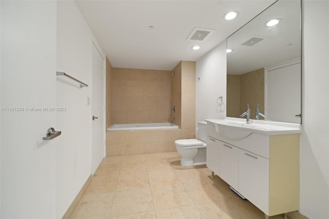 full bathroom with tile floors, toilet, vanity, and tiled shower / bath