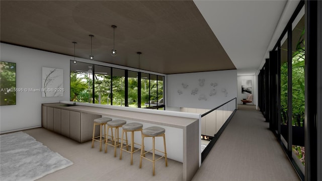 11500 SW 60th Ave, Pinecrest, FL 33156 - kitchen featuring light colored carpet, white cabinetry, a breakfast bar area, a sink, and pendant lighting