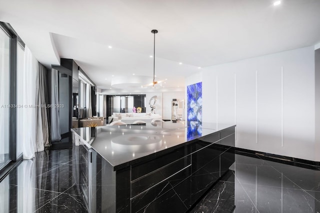 kitchen featuring pendant lighting and dark tile flooring