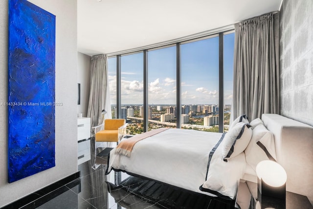 tiled bedroom with a wall of windows and multiple windows