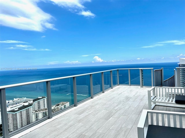 wooden terrace featuring a water view