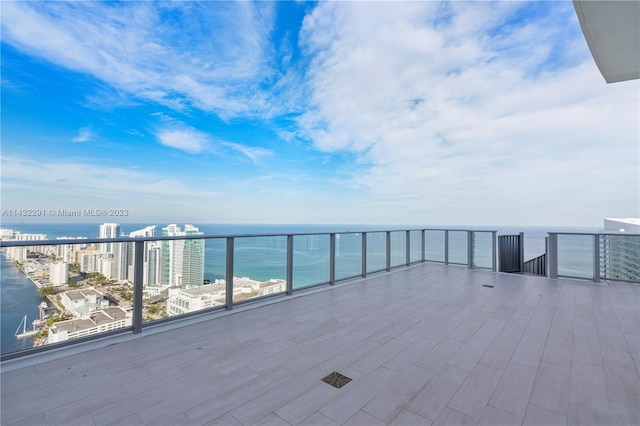 view of patio / terrace with a balcony and a water view