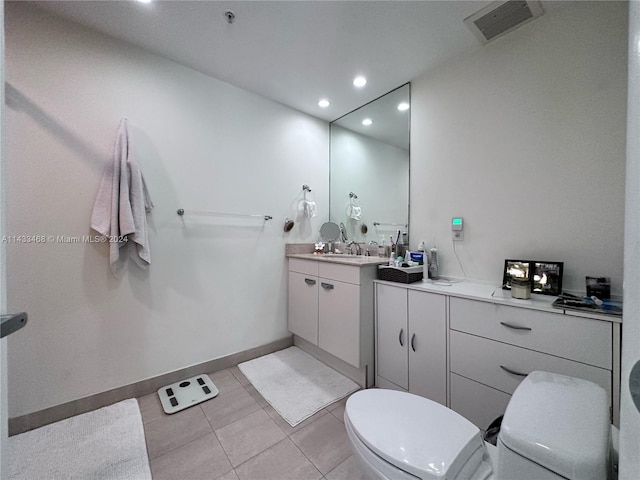 bathroom featuring tile patterned floors, vanity, and toilet