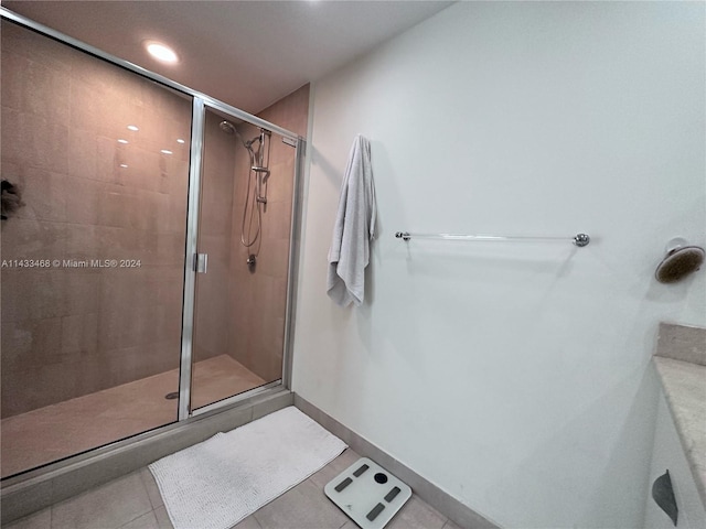 bathroom featuring tile patterned floors and an enclosed shower