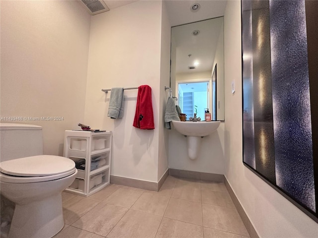 bathroom featuring tile patterned flooring and toilet