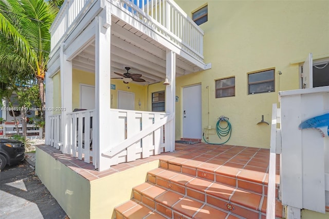 view of exterior entry with ceiling fan