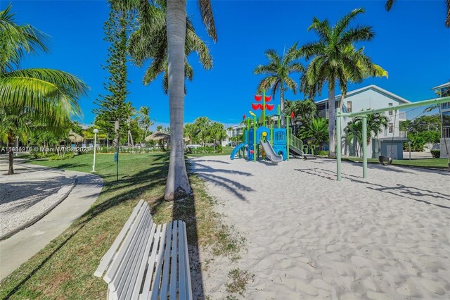 view of home's community with a playground and a lawn