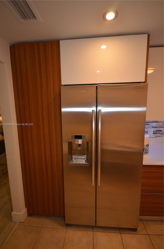 room details featuring light tile flooring and stainless steel built in refrigerator