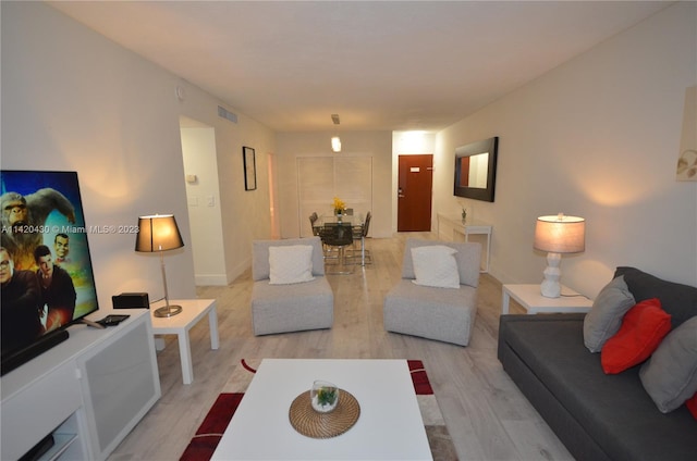 living room with light hardwood / wood-style flooring