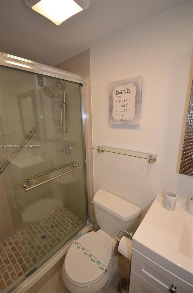 bathroom with walk in shower, toilet, and vanity