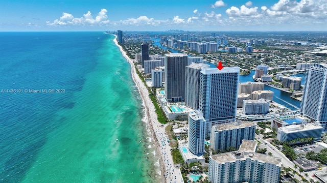 aerial view featuring a water view and a beach view