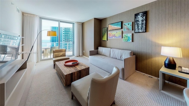 living room with light colored carpet and floor to ceiling windows