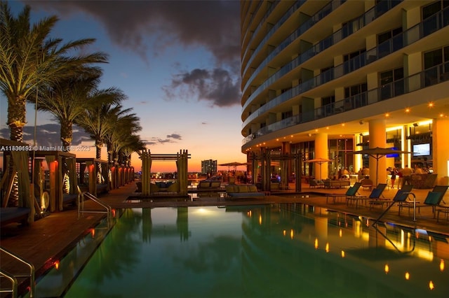 view of pool at dusk