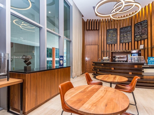 dining area featuring a notable chandelier and light tile floors