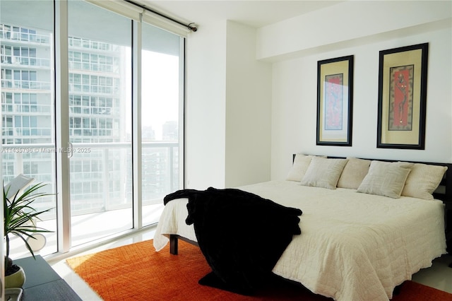 bedroom with a wall of windows and access to outside