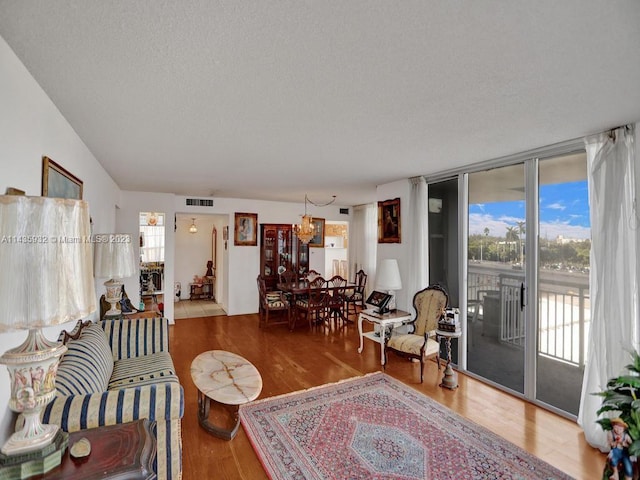 living room featuring a notable chandelier and hardwood / wood-style floors