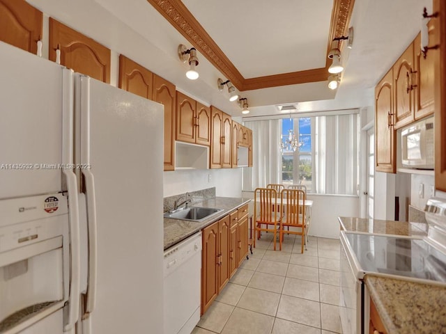 kitchen with white appliances, sink, crown molding, track lighting, and decorative light fixtures