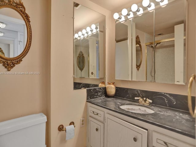 bathroom featuring toilet and vanity