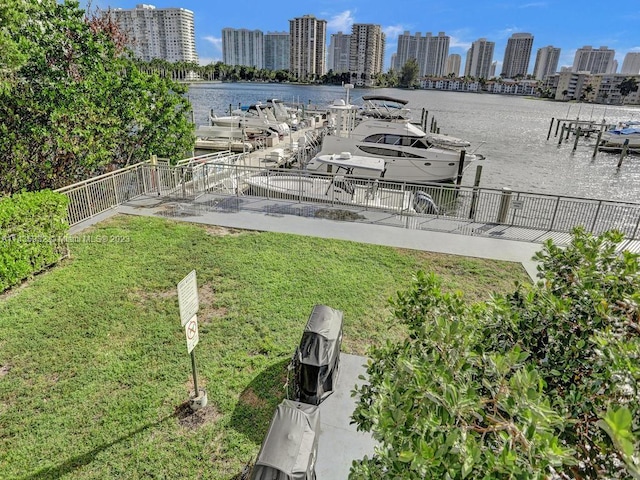 view of yard featuring a water view and a dock