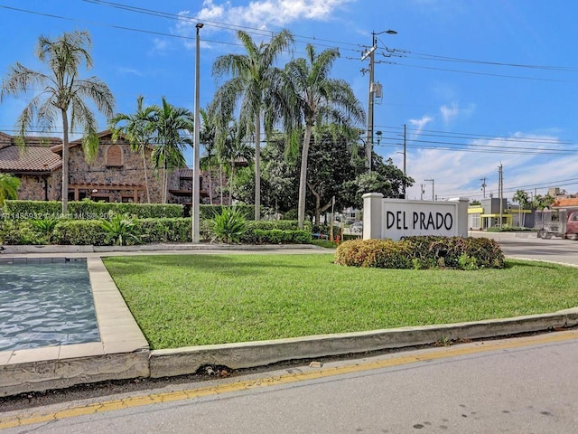 community sign featuring a yard