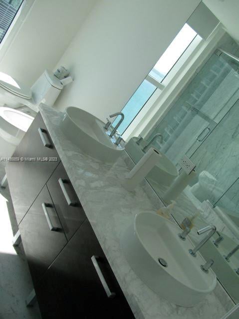 interior details with a skylight and double sink vanity