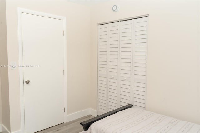 bedroom featuring a closet and light hardwood / wood-style flooring