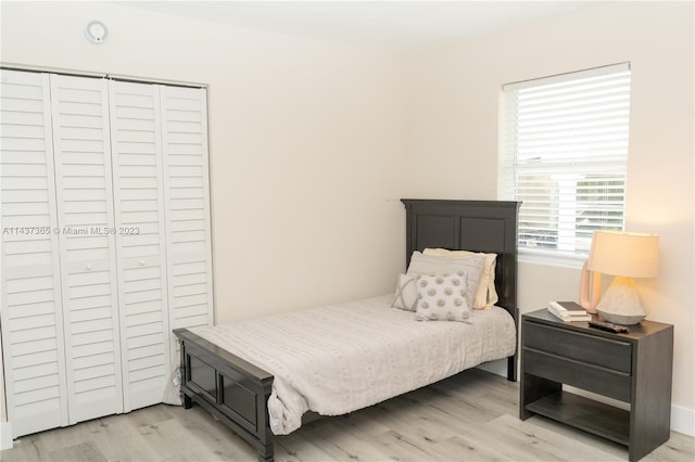 bedroom with light hardwood / wood-style floors and multiple windows